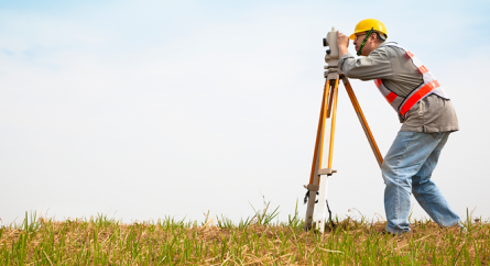 A surveyor in an open field.