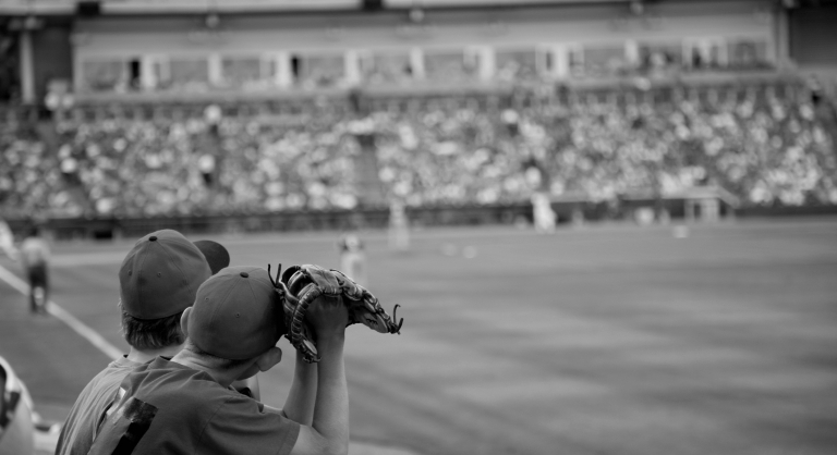 Young baseball fans at a game.