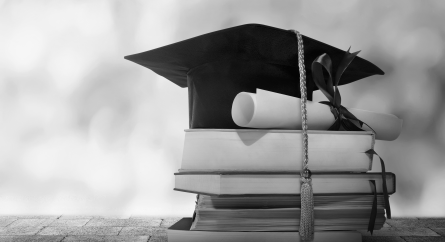 Graduation Cap with Diploma and books.