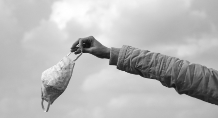 Person holding a cloth face mask.