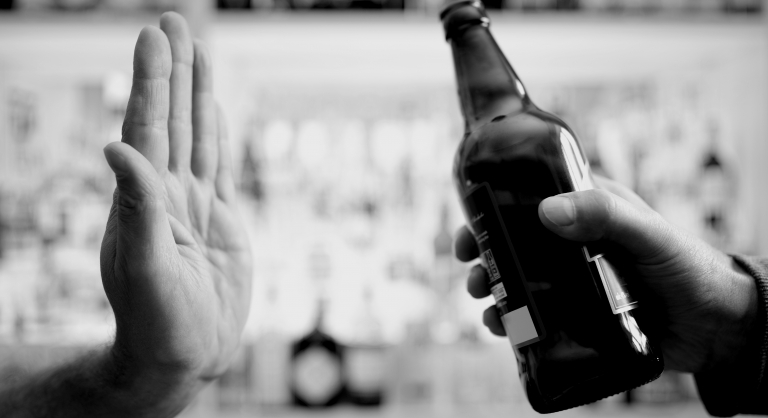 Hand rejecting alcoholic beer beverage.