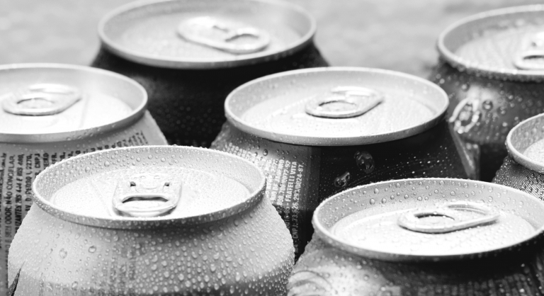 Beer cans covered in condensation.