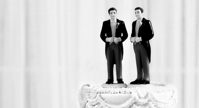 Two groom wedding cake toppers.