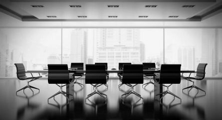 Empty boardroom with large class windows.