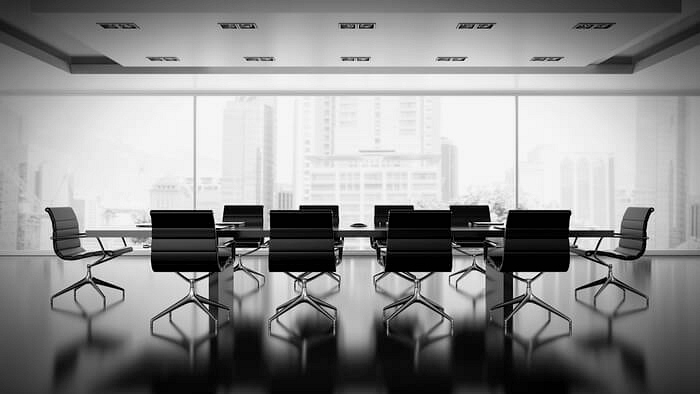 Empty boardroom with large class windows.
