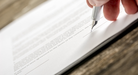 Person about to sign a document