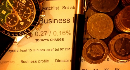 Money with pen and watch on financial data.