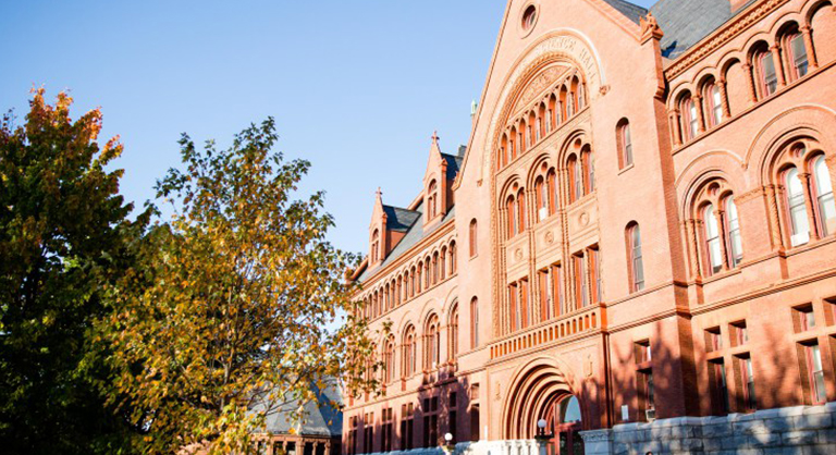 Outside shot of a large brick and stone college building.