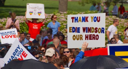Hand-made sign at a parade that says "Thank you Edie Windsor our hero".
