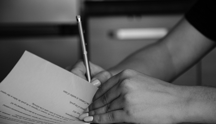 Young female signing legal documents