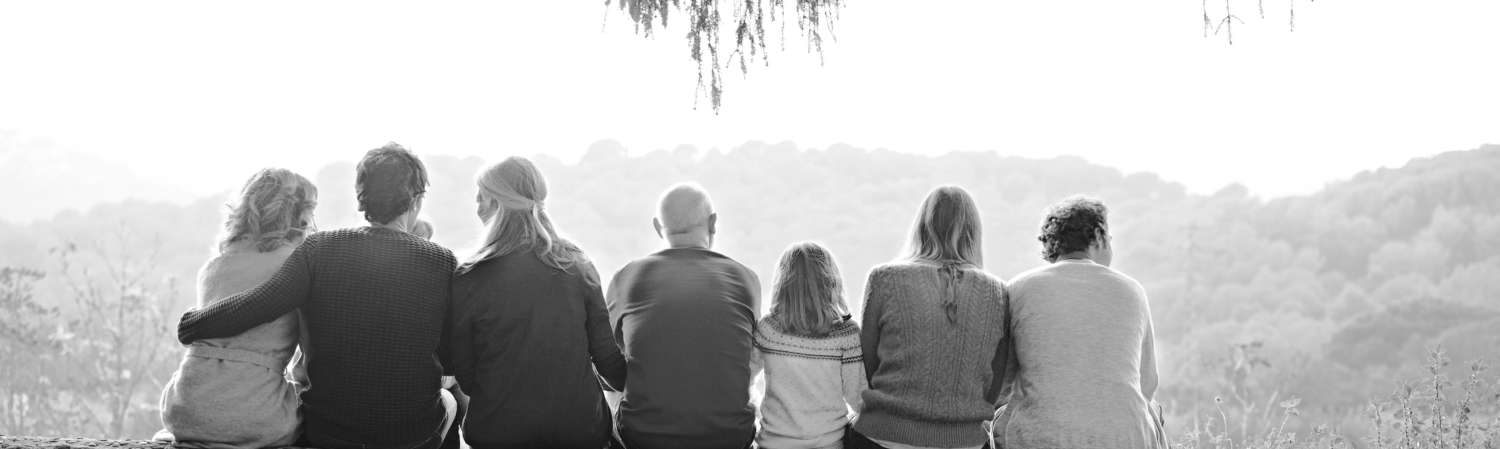 Multi-generation family sitting on wall