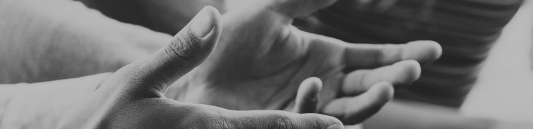 Close-up of hands gesturing as someone is talking.