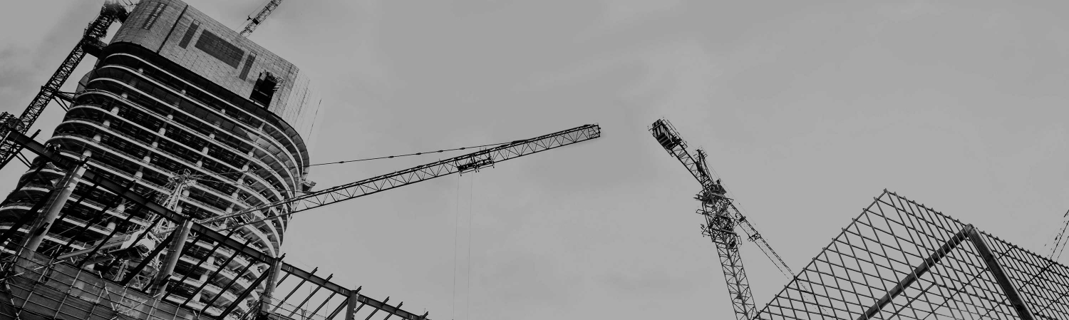 Up shot of a construction site with tall cranes.