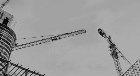 Up shot of a construction site with tall cranes.