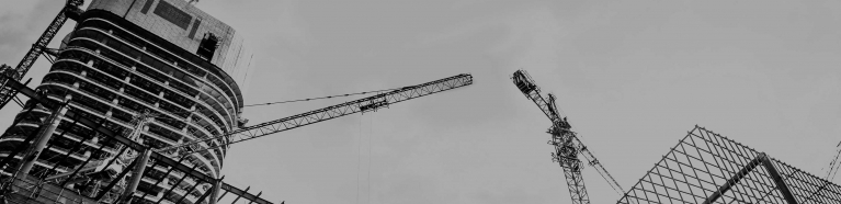 Up shot of a construction site with tall cranes.