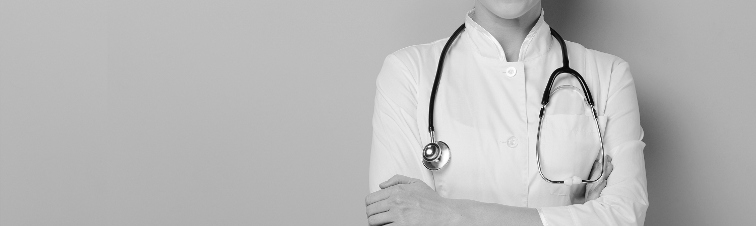 Healthcare professional with a stethoscope standing with their arms crossed.