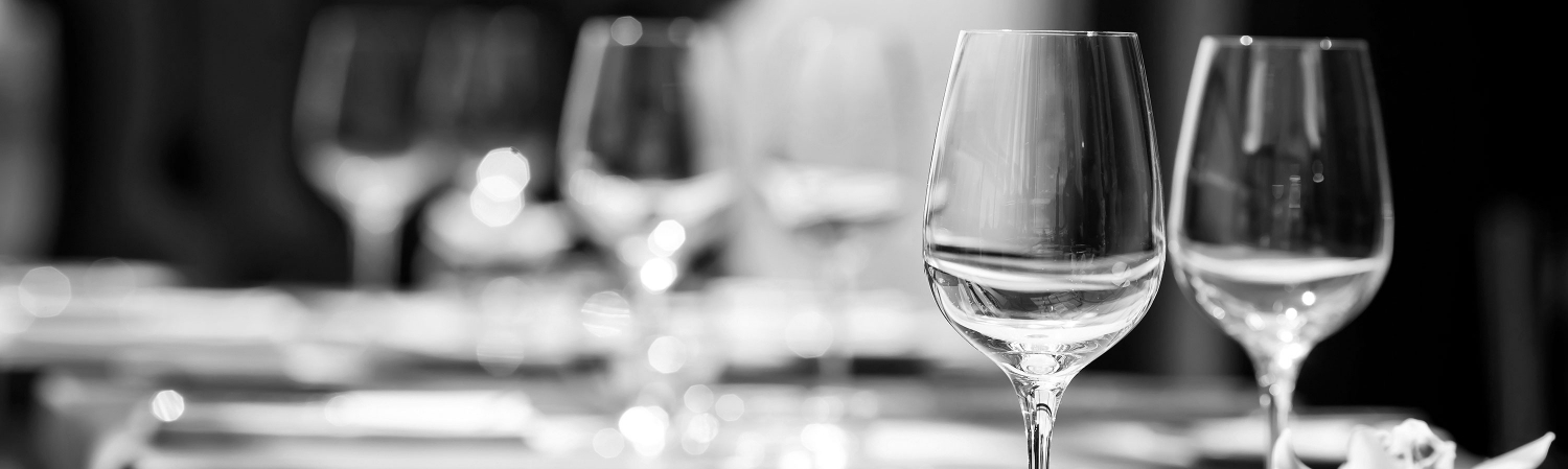 Wine glasses at a fancy dinner table.