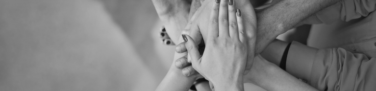 Team with their hands stacked together.