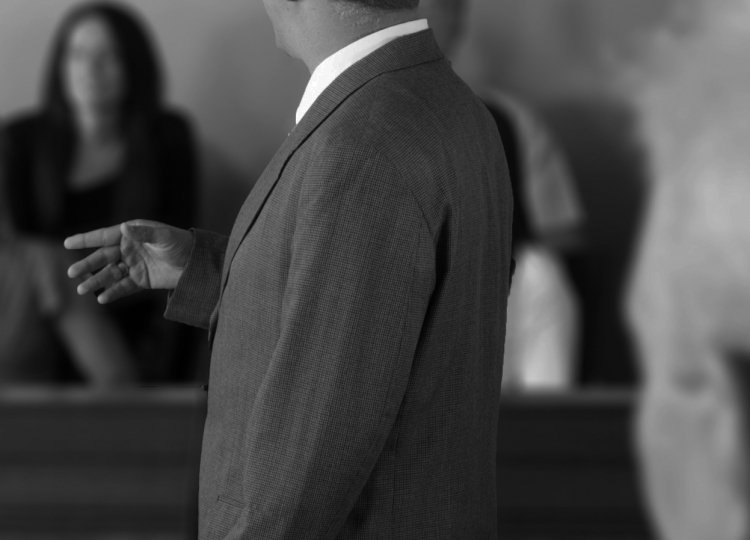 Male attorney addressing a jury.