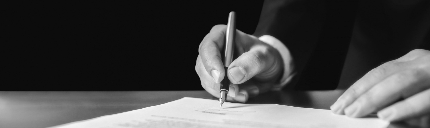 Person signing a contract.