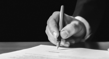 Person signing a contract.