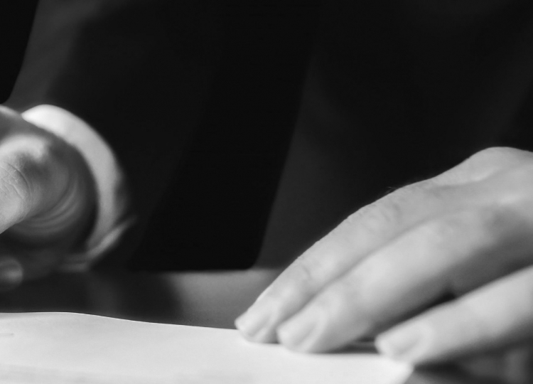 Person signing a contract.