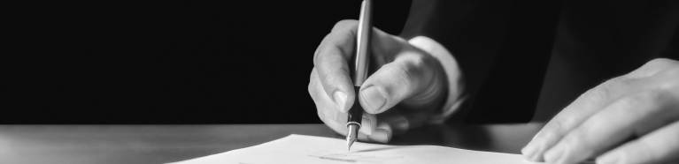 Person signing a contract.