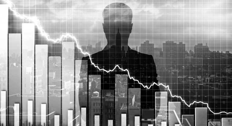 Plunging graph with silhouette of a businessperson and a city skyline behind it.