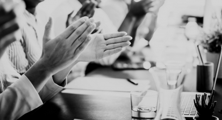 Close-up photo of partners clapping hands after business seminar.
