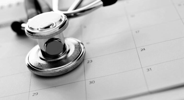 Close Up Of Stethoscope On Calendar.