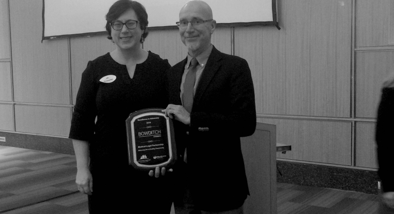Robert Cox and Samantha McDonald accepting the Excellence in Advocacy Award on behalf of Community Legal Aid.