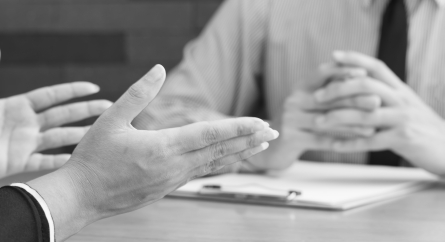 Close-up of hands during a job interview.