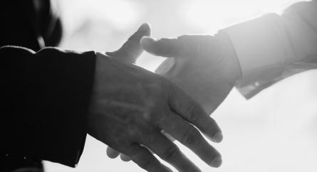 Business people greeting with handshake.