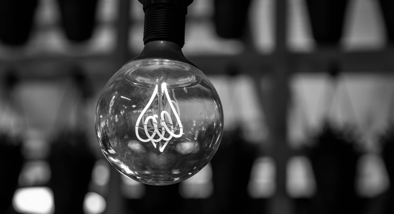 Close up of a single industrial-style light bulb.