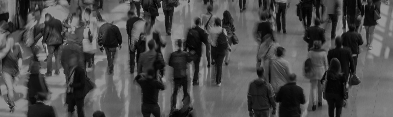 Blurry image of people walking in a crowded area.