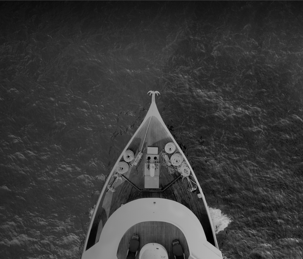 Overhead shot of the front of a boat on the open water.