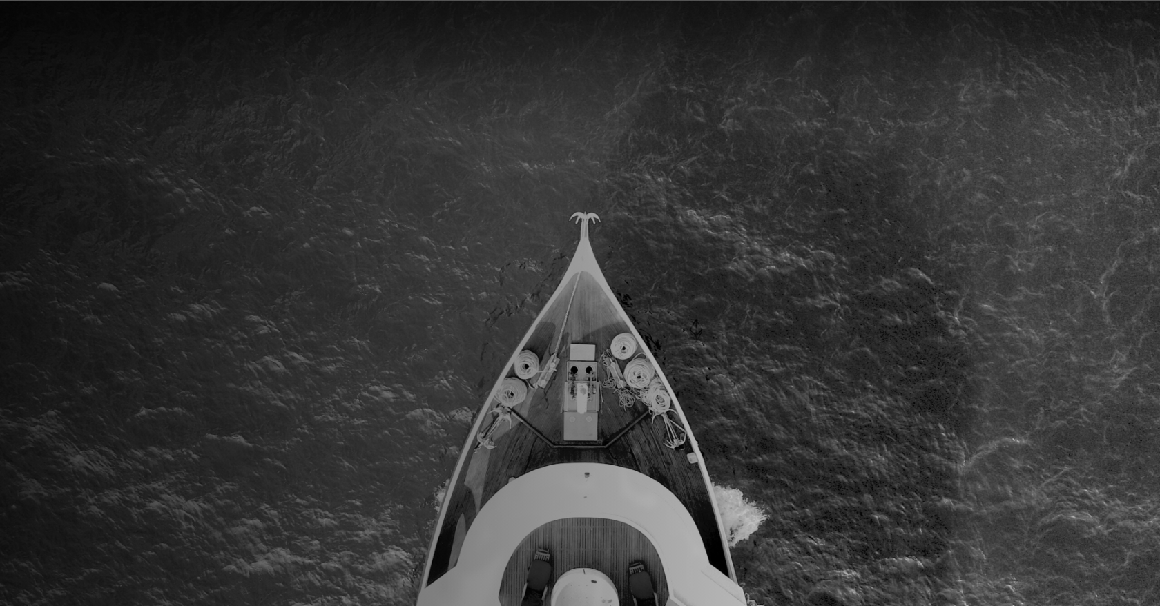 Overhead shot of the front of a boat on the open water.