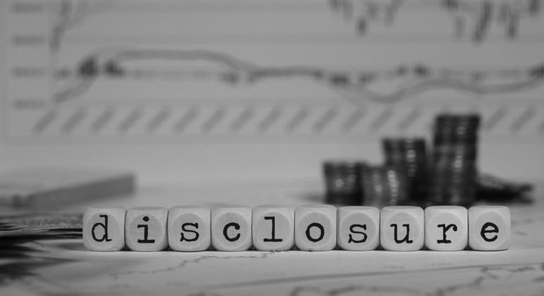 The word disclosure with coins and a financial graph
