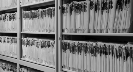 Shelves filled with colorfully labeled medical records