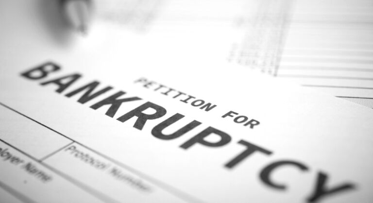 Image of a piece of paper with black text that says Petition for Bankruptcy