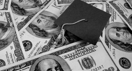 Graduation cap on a pile of money