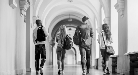 College students walking down a hallway.